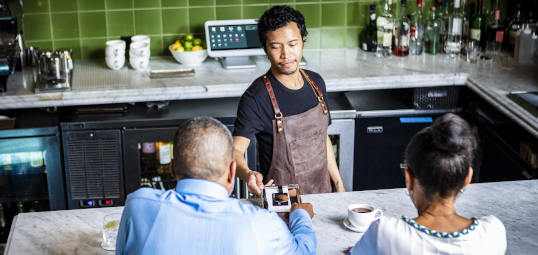 Woman paying at counter